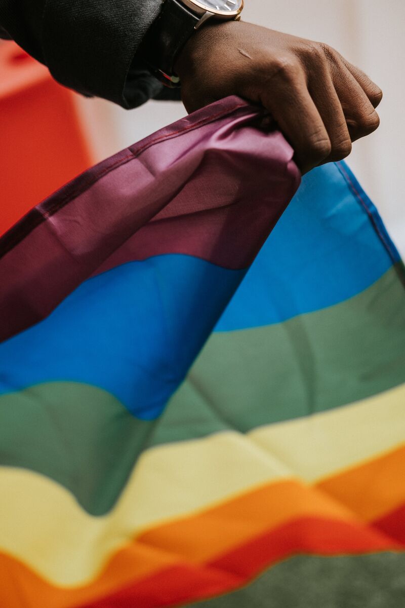 Close up of hand holding pride flag