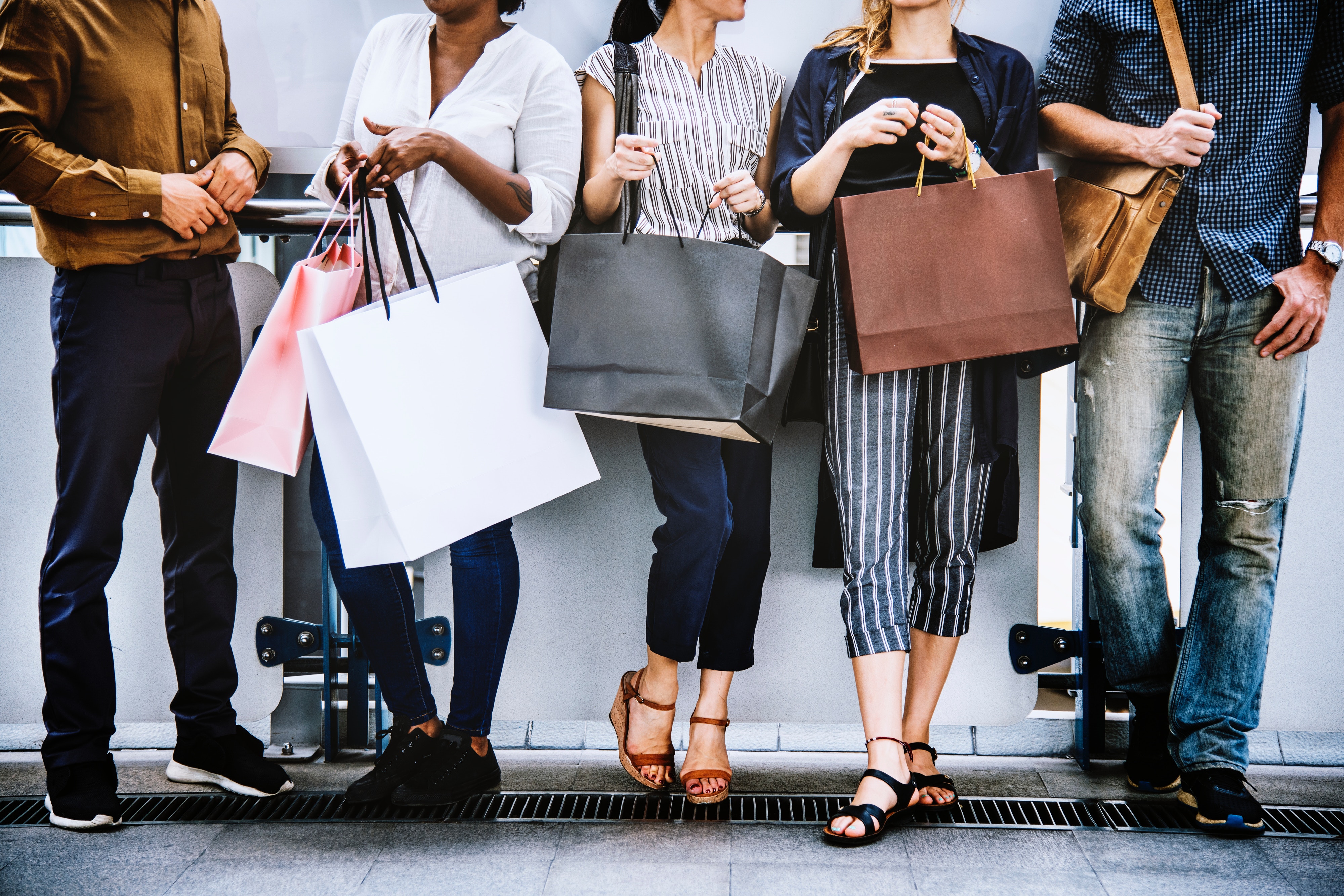 Group of people with shipping bags.