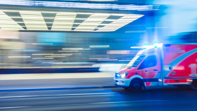 An ambulance rushes through a city