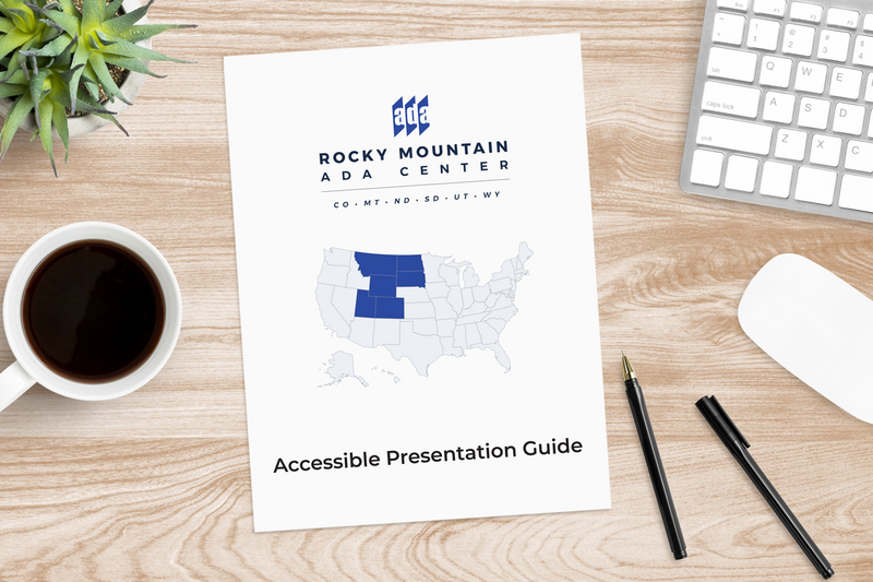Accessible guide document sitting on top of a desk with keyboard and coffee nearby.