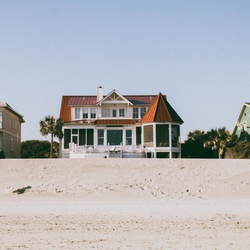 White and brown two-story house on the beach