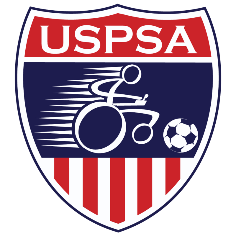 The official logo of the United States Power Soccer Association. A red, white, and blue shield with a wheelchair icon pushing a soccer ball.