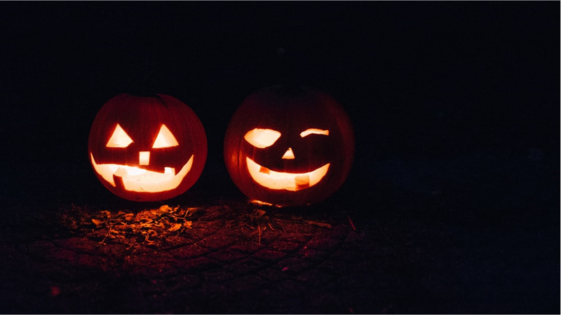 Two lighted jack-o-lanterns during night time. 