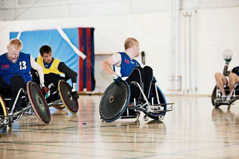 several men in wheelchairs playing wheelchair rugby