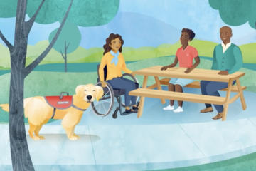 Service dog in part with three people at picnic table