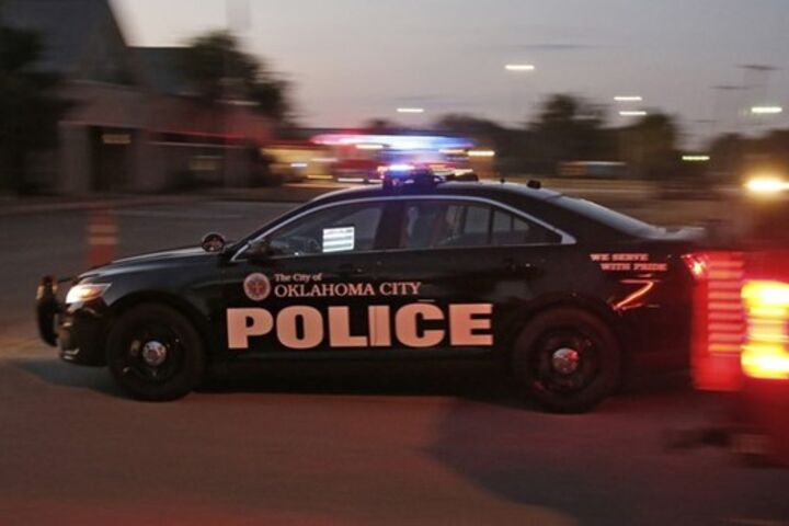 Oklahoma police car driving on a street.