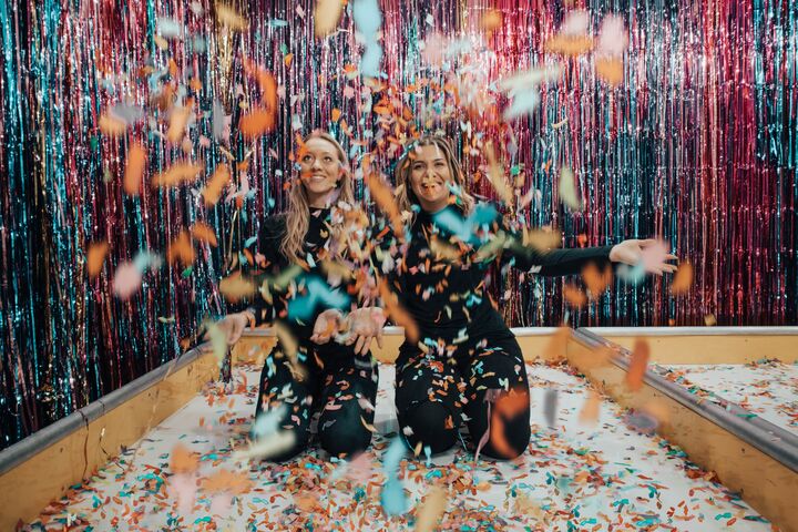 two people celebrating with confetti and streamers