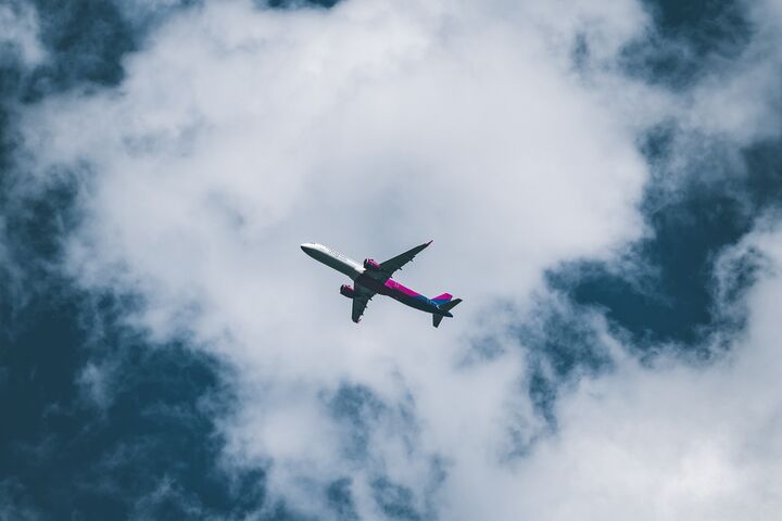 Airplane in the sky against a background of clouds. Photo by Erik Gazi on Unsplash