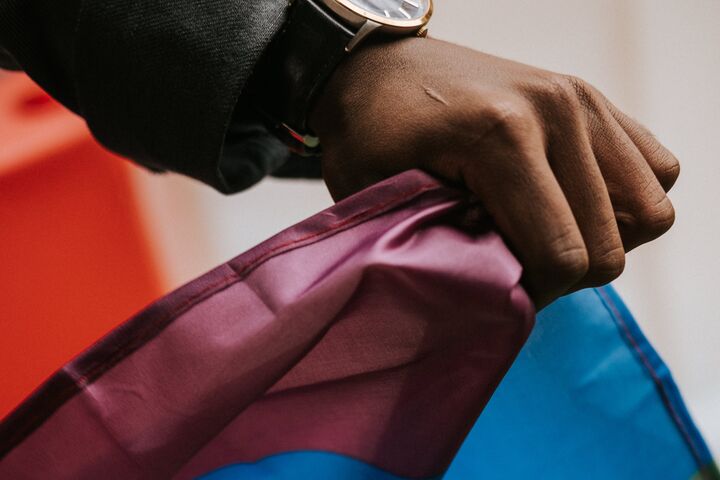 Close up of hand holding pride flag