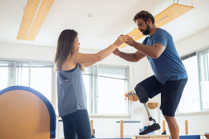 man with prosthetic leg in physical therapy