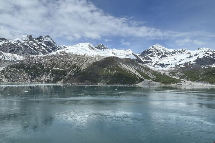 a pano of snowcapped mountains and a lake